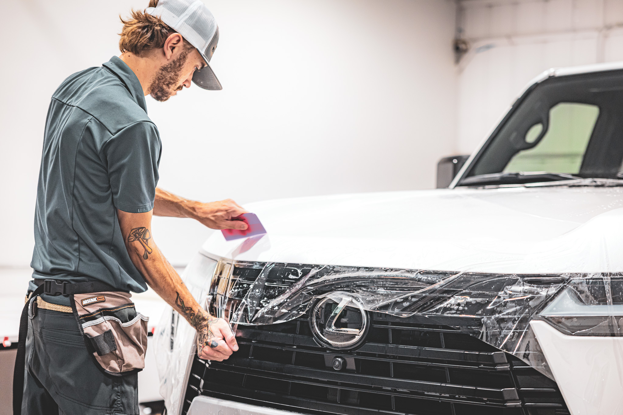 Paint Protection Film (PPF) 2 Car detailer applying film